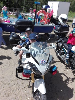 dzieci na łodzi policyjnej  i na motocyklach