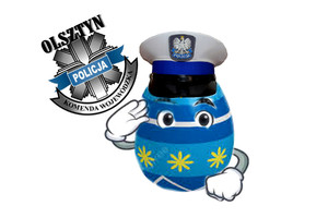 obrazek pisanki w czapce policyjnej, które oddaje honory, obok z lewej strony logo KWP Olsztyn