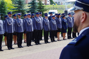 policjanci stojący w szyku na placu przed nimi dowódca uroczystości